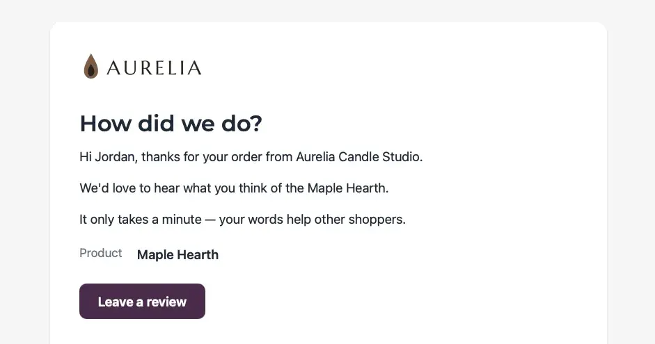 A review request email under the AURELIA wordmark, headed “How did we do?”, telling Jordan the studio would love to hear what they think of the Maple Hearth and that it only takes a minute because their words help other shoppers, with the product named on its own line above a dark plum Leave a review button.